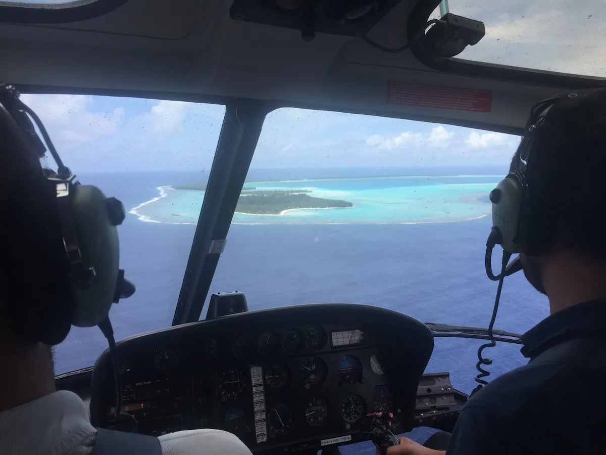 Teti’aroa’s lagoon and motu seen through the cockpit of an Air Tetiaroa aircraft